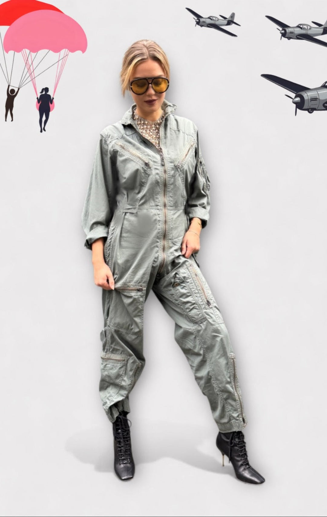 Person wearing a silver jumpsuit with parachutes and airplanes in the background